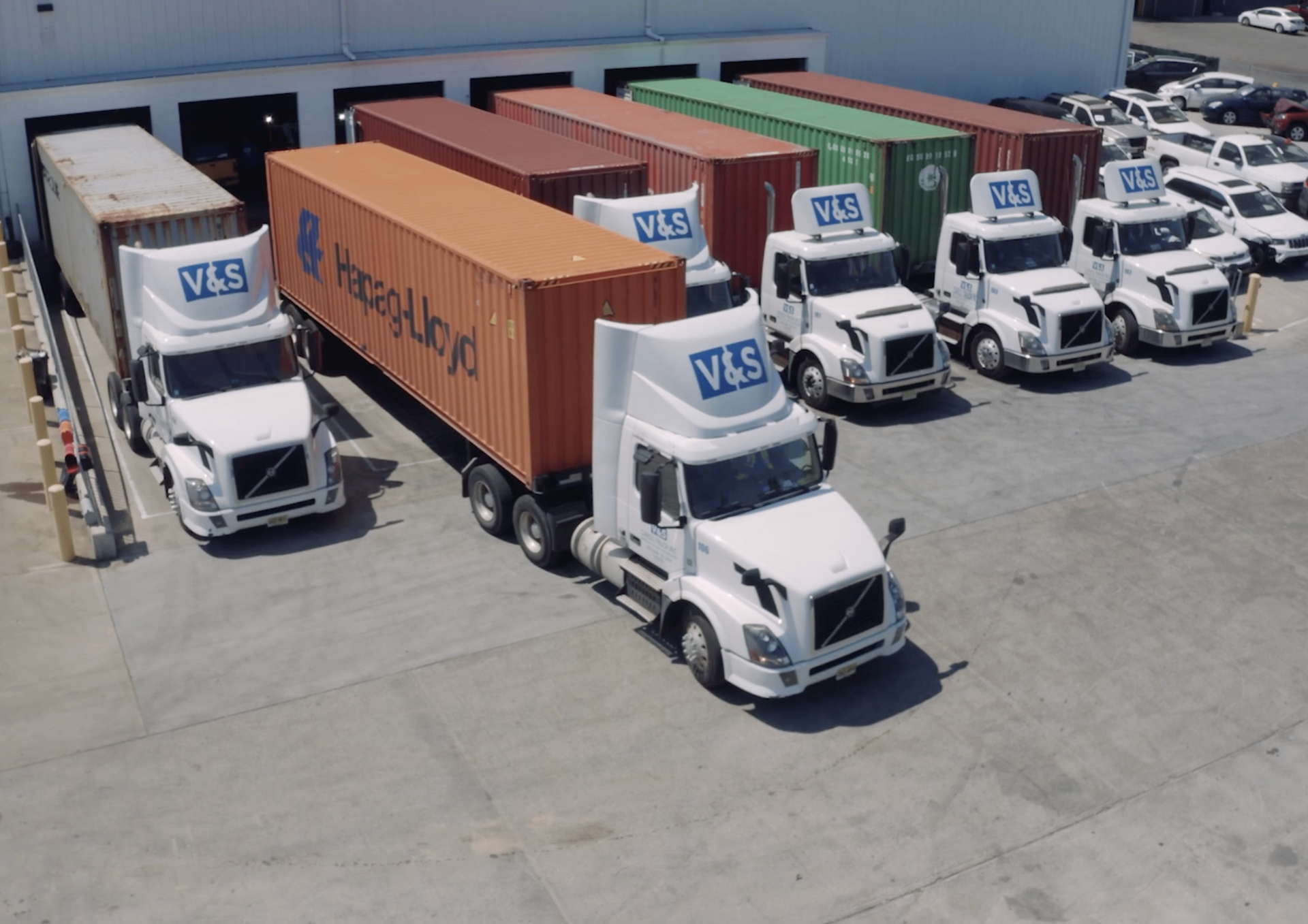 Vehicles being loaded into shipping containers at port